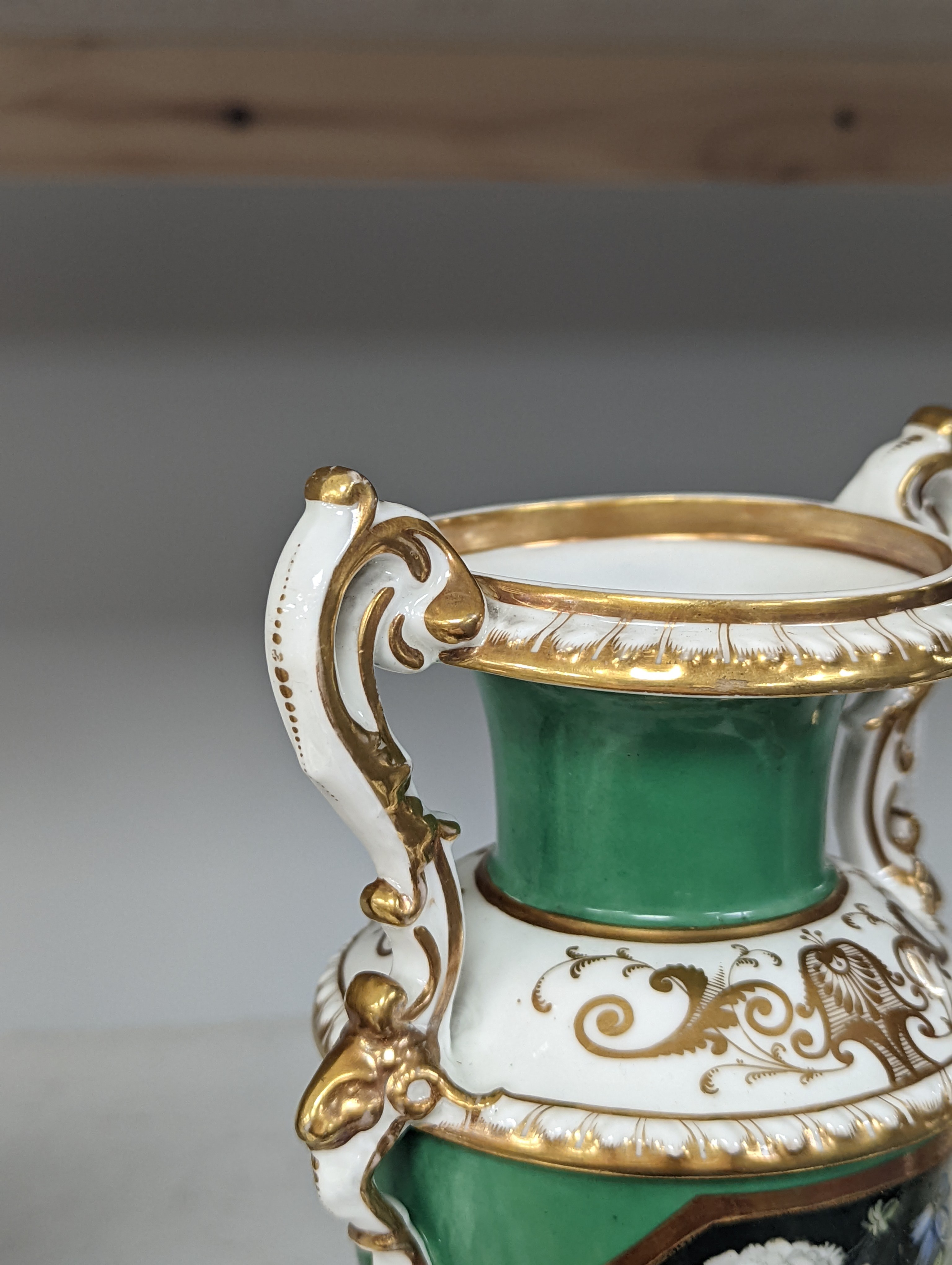 An English porcelain two handled vase painted with flowers in a panel on a green ground, probably Grainger Worcester, c.1830, height 24cm